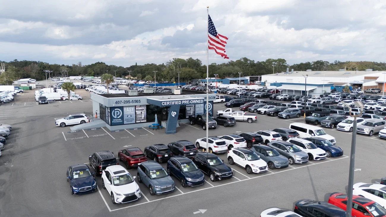 Used Ford SUVs including an Explorer and a Mustang Mach-E on the lot at Orlando Preowned on W. Colonial Drive