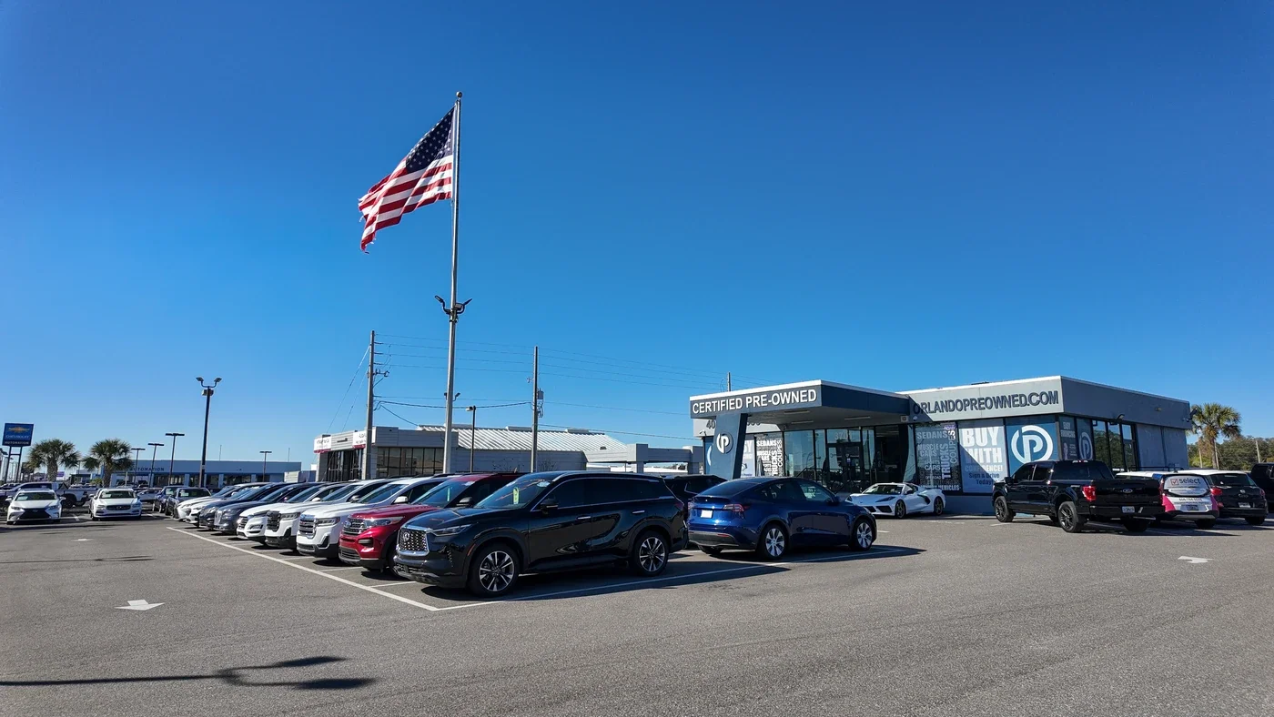 Wide view of the Orlando Preowned vehicle lot at 3701 W Colonial Dr, Orlando, FL, certified pre-owned cars and SUVs on the lot