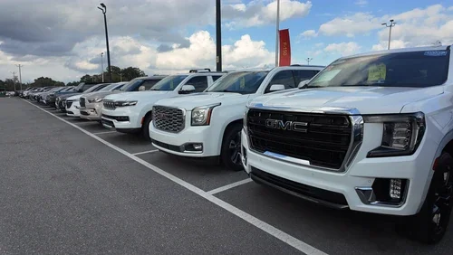 Row of inspected pre-owned trucks and SUVs at Orlando Preowned, Orlando, FL